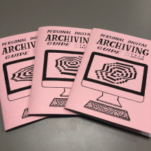 Copies of the Personal Digital Archiving zine, featuring a cover drawing of a desktop computer with a rasterized spiral on the screen
