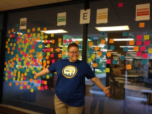 Photo of Faith with colorful Post-It notes stuck to a window