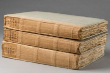spines of three bound books stacked on top of each other